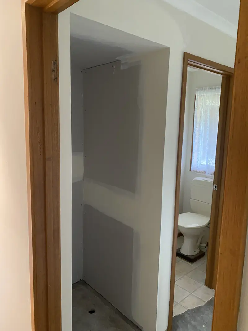 Plasterer working on heritage property walls during renovation in regional Victoria